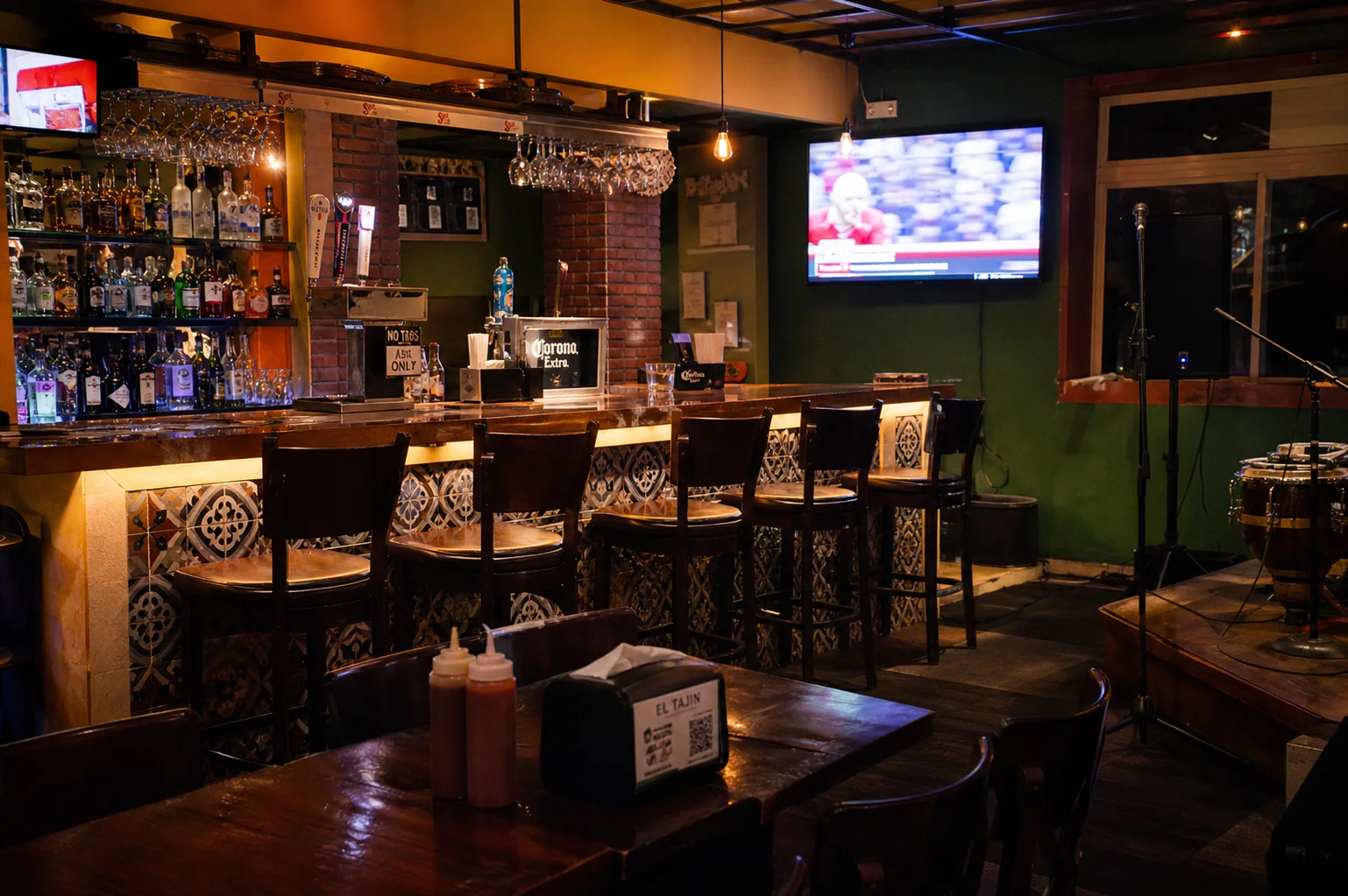 Warm neighborhood Latin bar with beer taps television and a small music corner
